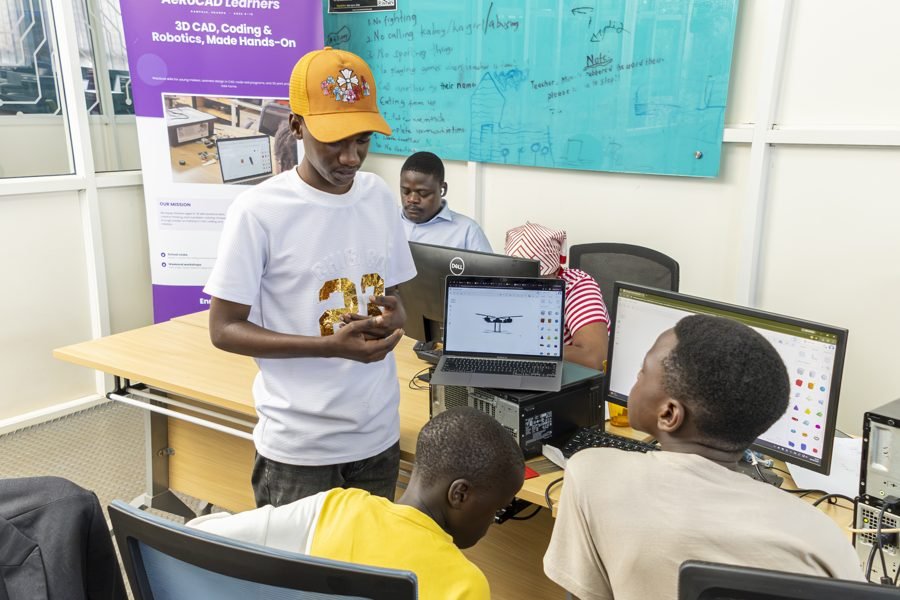 A learner showing a 3D CAD design to classmates